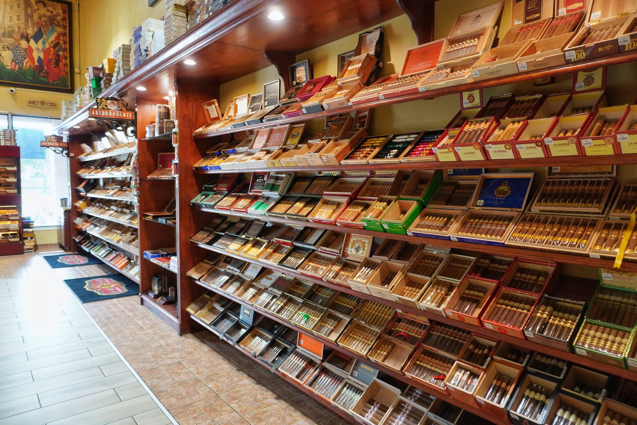 Wall of open cigar boxes in the walk-in humidor at Sabor Havana in Doral