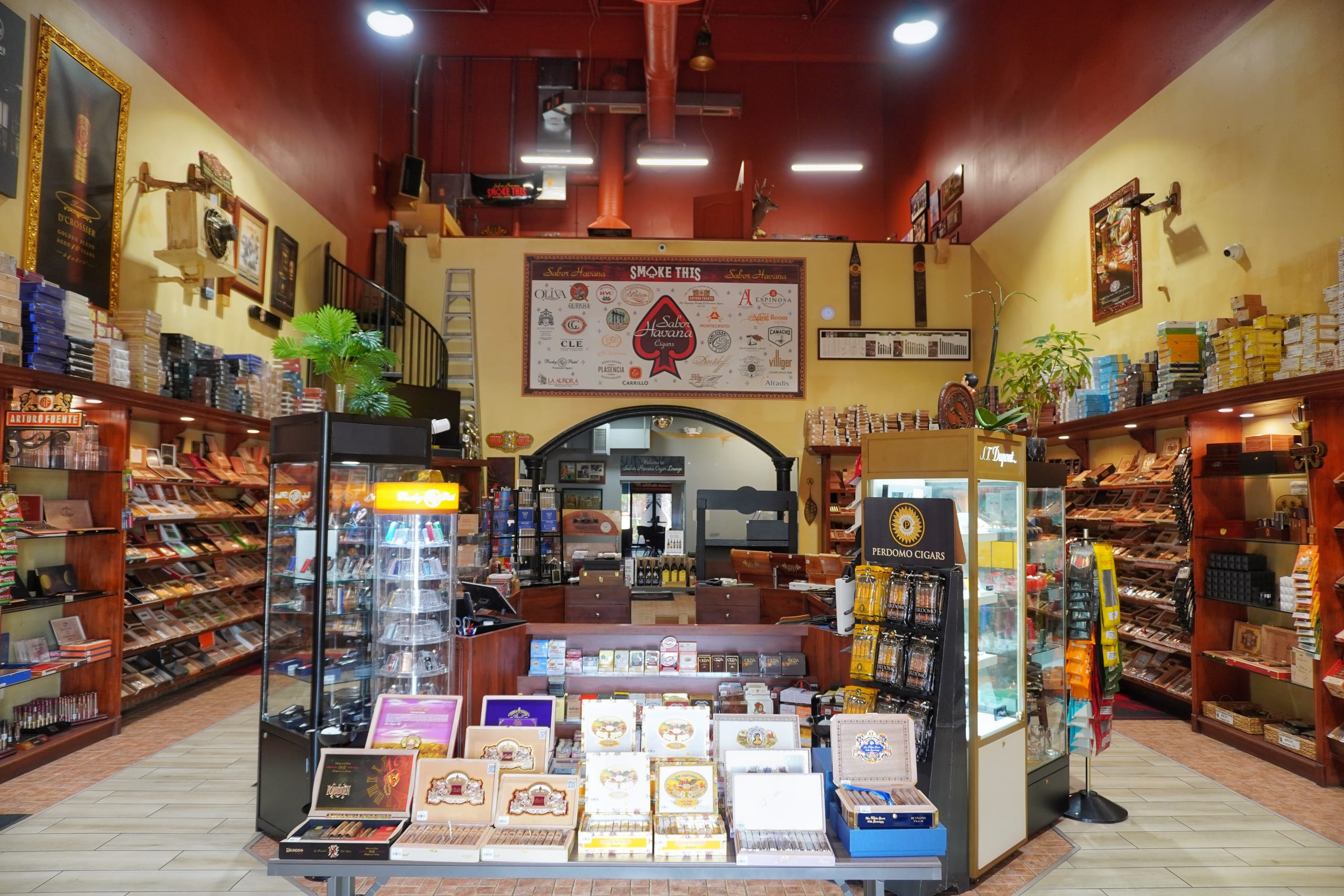 The walk-in humidor at Sabor Havana in Doral, Miami, lined floor to ceiling with open cigar boxes